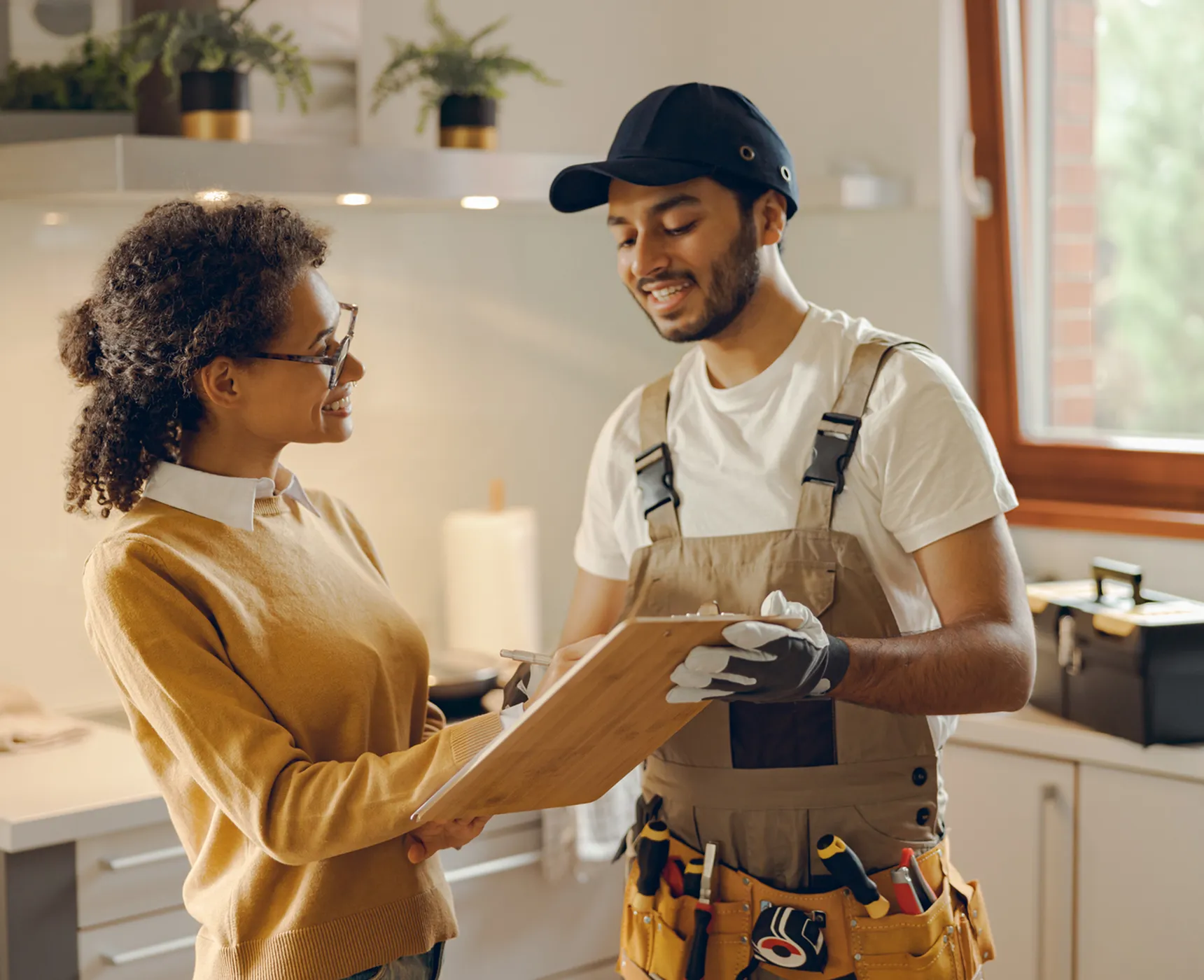 Woman and handyman discussing home repair plan.